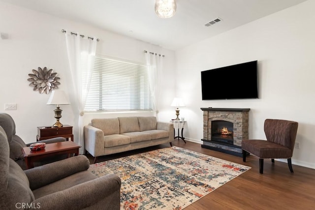24190 Evesong Dr, Corona, CA 92883 - living area with wood finished floors, baseboards, and a stone fireplace