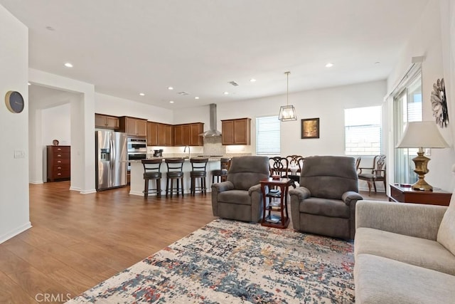 24190 Evesong Dr, Corona, CA 92883 - living area with healthy amount of natural light, wood finished floors, and recessed lighting