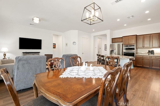 24190 Evesong Dr, Corona, CA 92883 - dining area with recessed lighting, wood finished floors, and a chandelier