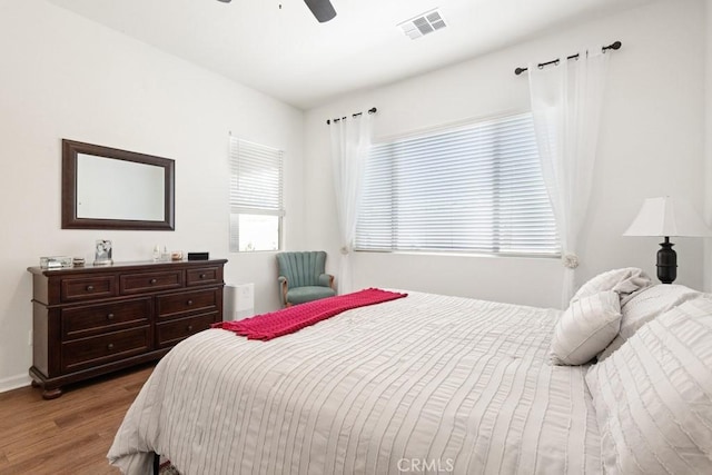 24190 Evesong Dr, Corona, CA 92883 - bedroom with wood finished floors, multiple windows, and a ceiling fan