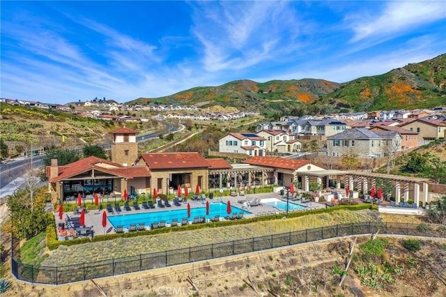 24190 Evesong Dr, Corona, CA 92883 - back of property featuring a community pool, a mountain view, a residential view, and a patio
