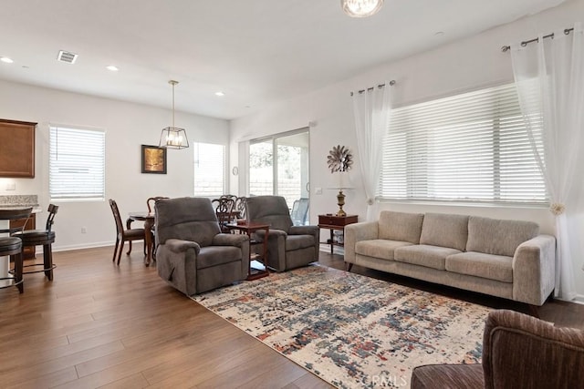 24190 Evesong Dr, Corona, CA 92883 - living area with plenty of natural light, baseboards, wood finished floors, recessed lighting, and a chandelier