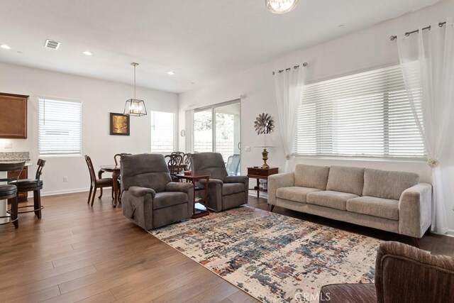 24190 Evesong Dr, Corona, CA 92883 - living area with healthy amount of natural light, wood finished floors, recessed lighting, and a chandelier