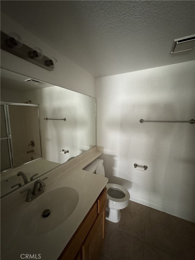 3178 Dogwood Dr, Corona, CA 92882 - full bathroom with vanity, toilet, an enclosed shower, tile patterned floors, and a textured ceiling