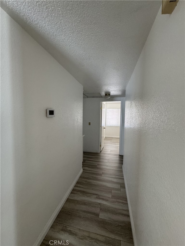 3178 Dogwood Dr, Corona, CA 92882 - corridor with baseboards, a textured ceiling, a textured wall, and wood finished floors