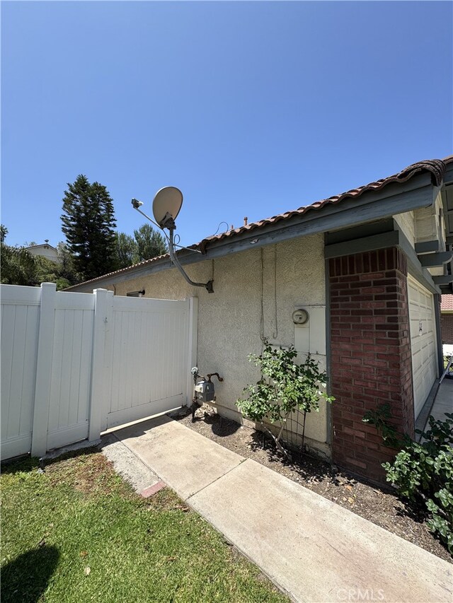 3178 Dogwood Dr, Corona, CA 92882 - view of property exterior with stucco siding and a gate