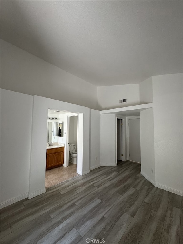 3178 Dogwood Dr, Corona, CA 92882 - unfurnished bedroom featuring wood finished floors, a sink, baseboards, and ensuite bath