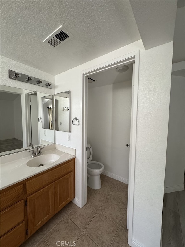 3178 Dogwood Dr, Corona, CA 92882 - bathroom featuring vanity, toilet, a textured ceiling, tile patterned floors, and baseboards
