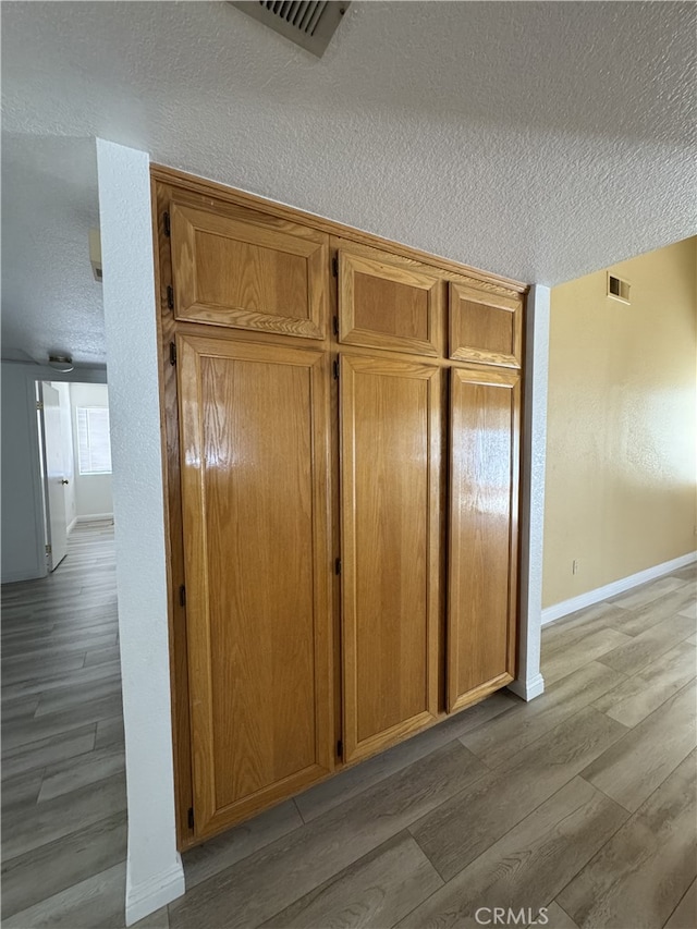 3178 Dogwood Dr, Corona, CA 92882 - detailed view of a textured ceiling, wood finished floors, and baseboards