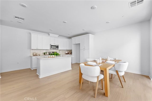 94231/2 N Sepulveda Blvd Unit 4, North Hills, CA 91343 - dining area featuring light wood-style floors and baseboards