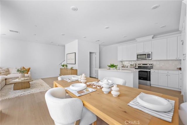 94231/2 N Sepulveda Blvd Unit 4, North Hills, CA 91343 - dining area with light wood-type flooring