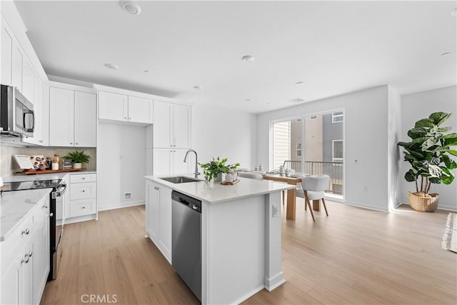 94231/2 N Sepulveda Blvd Unit 4, North Hills, CA 91343 - kitchen featuring a sink, appliances with stainless steel finishes, light wood-style floors, and white cabinets