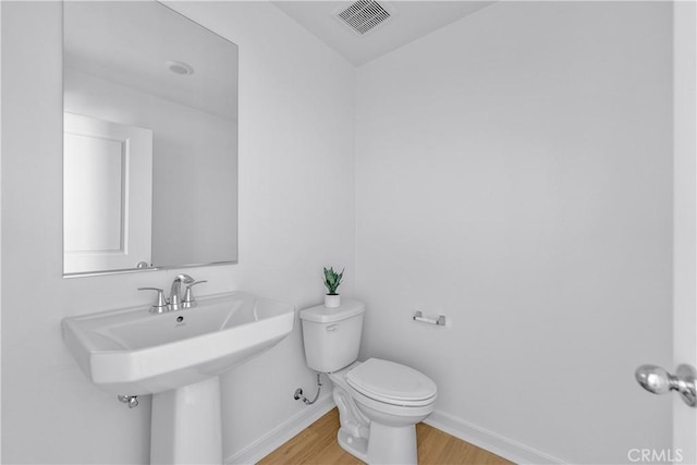 94231/2 N Sepulveda Blvd Unit 4, North Hills, CA 91343 - half bath featuring wood finished floors, toilet, and baseboards