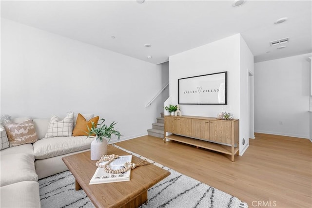 94231/2 N Sepulveda Blvd Unit 4, North Hills, CA 91343 - living room featuring stairs, light wood-style floors, and baseboards