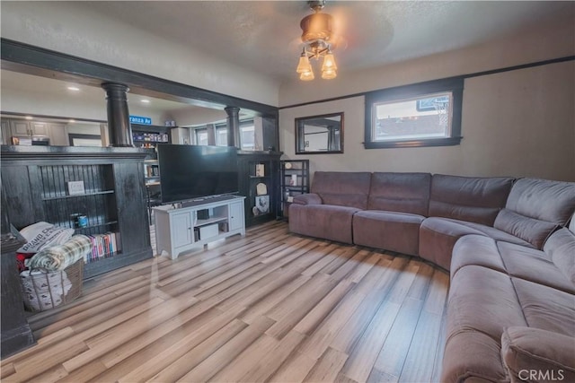 5837 Esperanza Ave, Whittier, CA 90606 - living area with ornate columns, light wood-type flooring, and ceiling fan