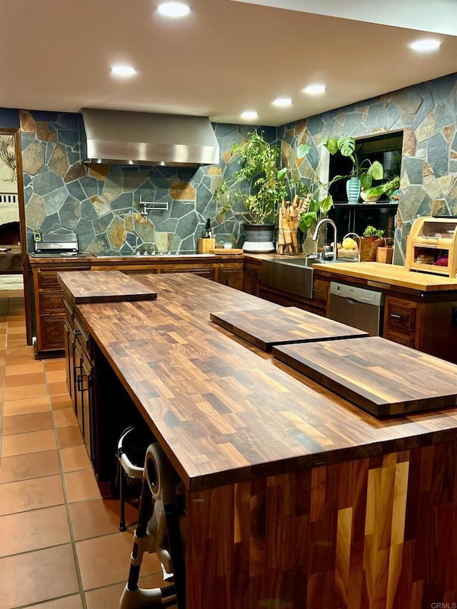 2073 Elevado Rd, Vista, CA 92084 - kitchen featuring butcher block counters, wall chimney exhaust hood, stainless steel dishwasher, light tile patterned flooring, and recessed lighting