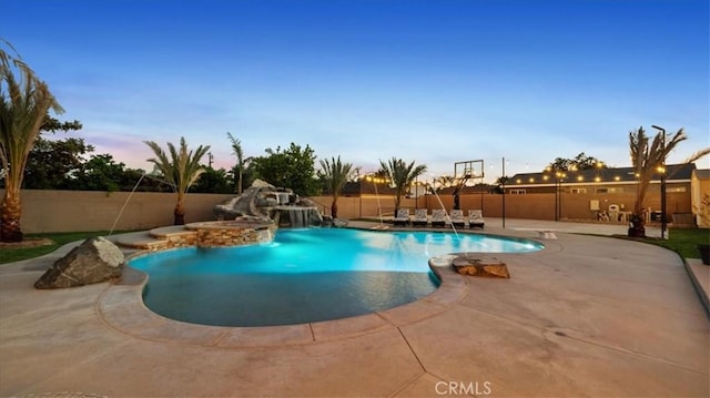 17623 Pine Ave, Fontana, CA 92335 - pool at dusk featuring a fenced backyard, a patio area, and a jacuzzi