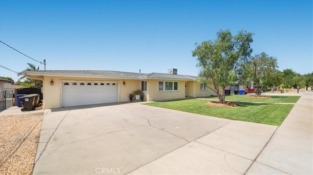 17623 Pine Ave, Fontana, CA 92335 - single story home with concrete driveway, a garage, a front yard, and stucco siding