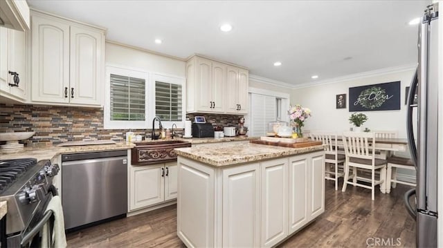 17623 Pine Ave, Fontana, CA 92335 - kitchen with appliances with stainless steel finishes, a sink, ornamental molding, decorative backsplash, and dark wood-style floors