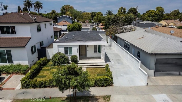 3037 Pacific Ave, Long Beach, CA 90806 - view of front of house with a residential view, stucco siding, a garage, and covered porch