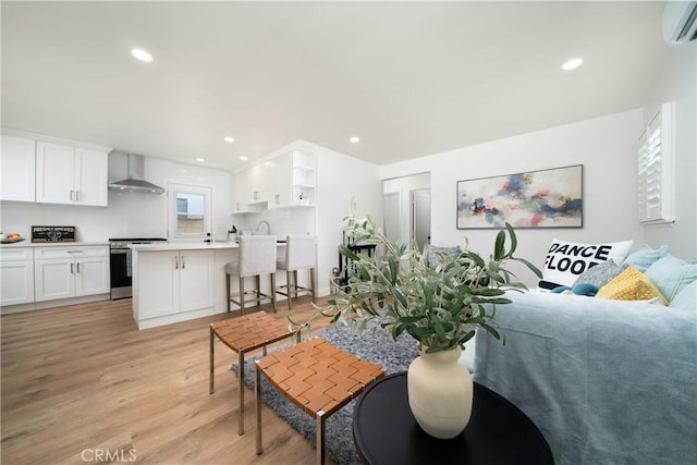 3037 Pacific Ave, Long Beach, CA 90806 - living room with light wood-style flooring, a wall mounted AC, and recessed lighting