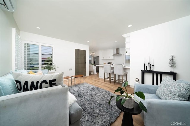 3037 Pacific Ave, Long Beach, CA 90806 - living room featuring a chandelier, light wood finished floors, a wall mounted air conditioner, and recessed lighting