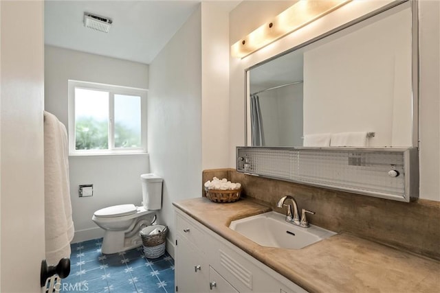 1516 Downing Ave, Chico, CA 95926 - full bath featuring vanity, toilet, tasteful backsplash, tile patterned floors, and a shower with shower curtain