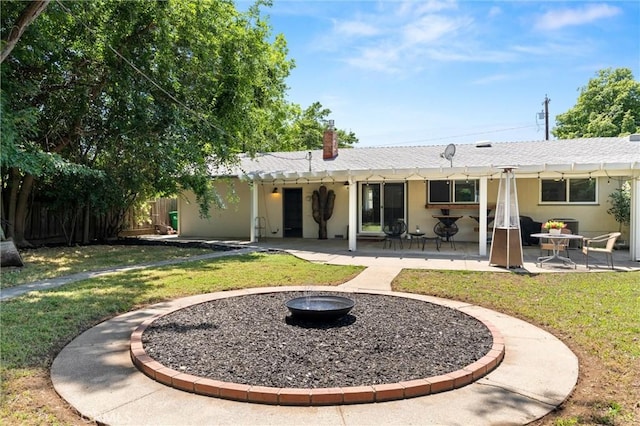 1516 Downing Ave, Chico, CA 95926 - back of house featuring a patio, an outdoor fire pit, a chimney, and stucco siding