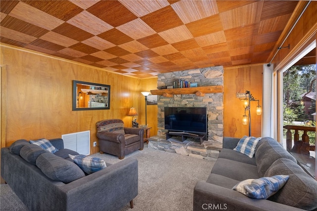 39162 Manzanita, Bass Lake, CA 93604 - living area featuring wood ceiling, carpet, wooden walls, and a stone fireplace