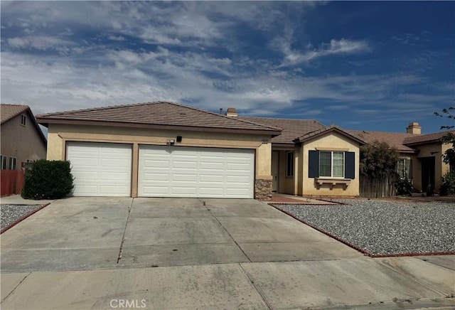 14543 Handsdale St, Adelanto, CA 92301 - ranch-style home with concrete driveway, a garage, stucco siding, and a tiled roof