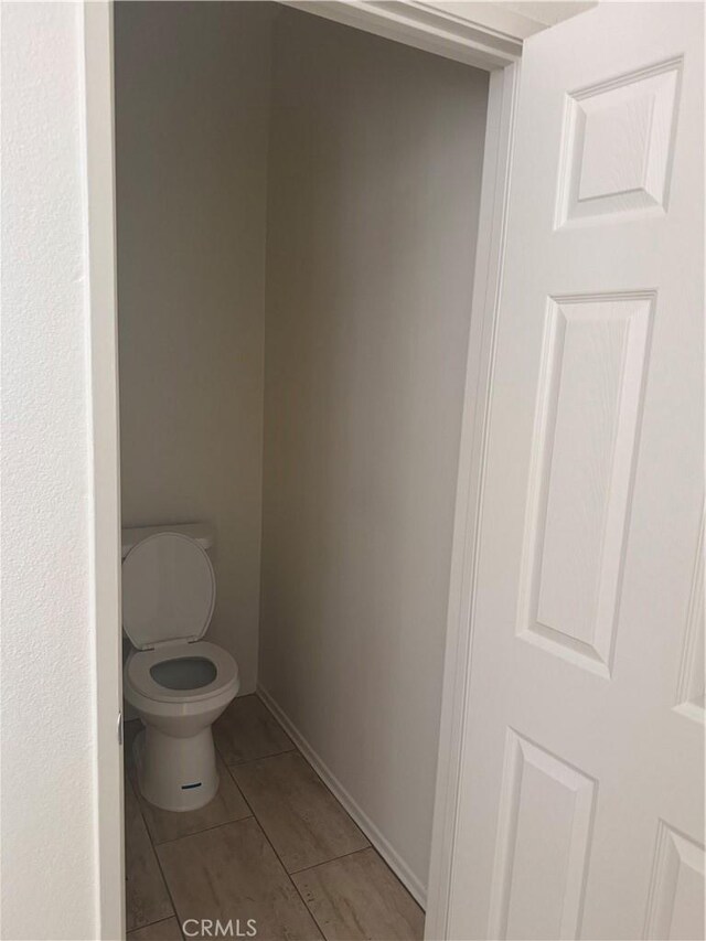 14543 Handsdale St, Adelanto, CA 92301 - bathroom featuring toilet, tile patterned floors, and baseboards
