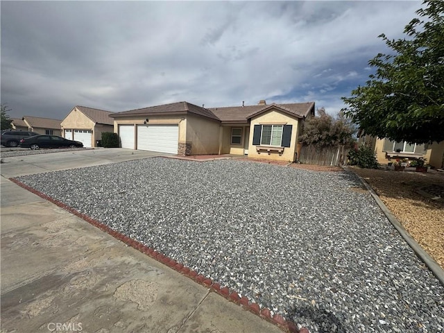 14543 Handsdale St, Adelanto, CA 92301 - ranch-style house with stucco siding, a garage, and concrete driveway