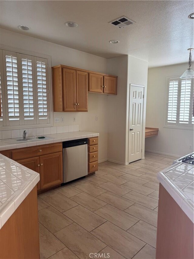 14543 Handsdale St, Adelanto, CA 92301 - kitchen featuring tile counters, stainless steel dishwasher, a sink, and baseboards