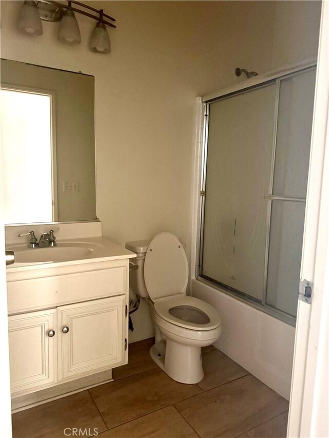 14543 Handsdale St, Adelanto, CA 92301 - bathroom with vanity, toilet, combined bath / shower with glass door, and tile patterned floors