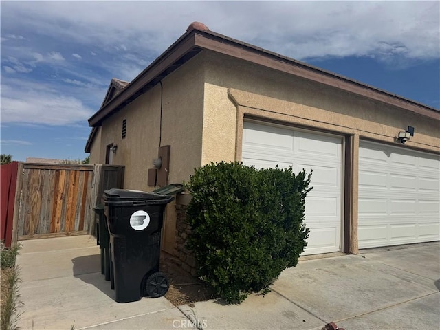 14543 Handsdale St, Adelanto, CA 92301 - view of side of home featuring stucco siding and a garage
