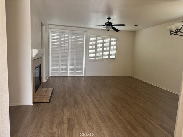 14543 Handsdale St, Adelanto, CA 92301 - unfurnished living room featuring a tiled fireplace, a ceiling fan, wood finished floors, and baseboards
