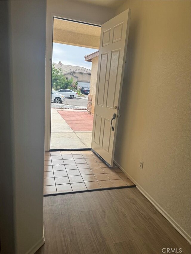 14543 Handsdale St, Adelanto, CA 92301 - doorway with baseboards and wood finished floors