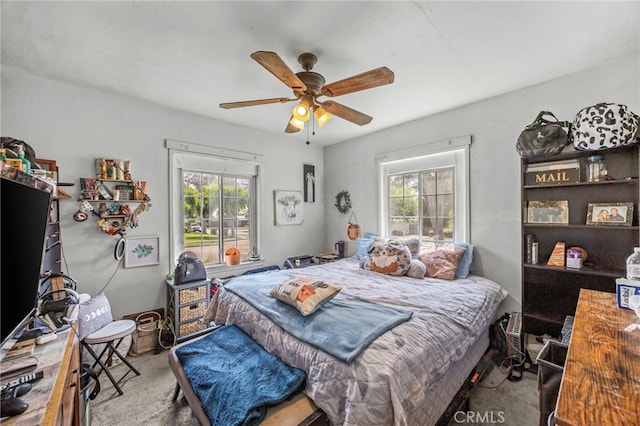 4909 Sepulveda Ave, San Bernardino, CA 92404 - carpeted bedroom featuring multiple windows and a ceiling fan