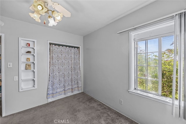 4909 Sepulveda Ave, San Bernardino, CA 92404 - unfurnished room with a ceiling fan, plenty of natural light, carpet flooring, and built in shelves