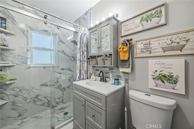 4909 Sepulveda Ave, San Bernardino, CA 92404 - bathroom with a marble finish shower, toilet, vanity, and backsplash