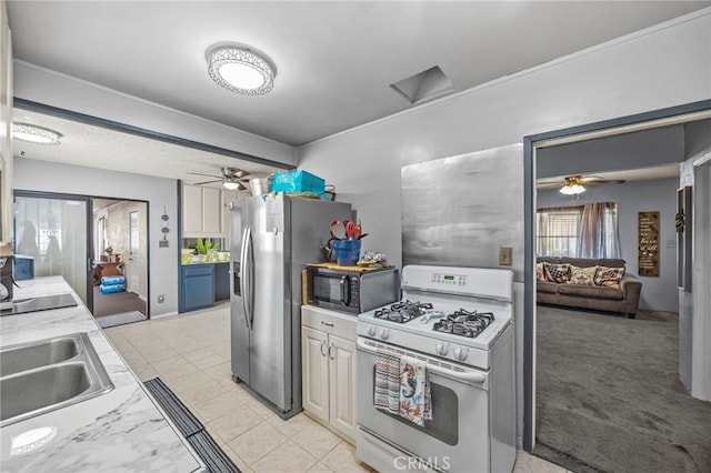 4909 Sepulveda Ave, San Bernardino, CA 92404 - kitchen with black appliances, ceiling fan, light countertops, and a sink