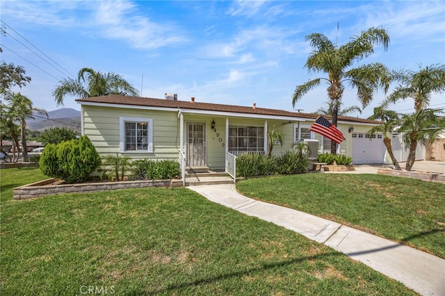 4909 Sepulveda Ave, San Bernardino, CA 92404 - ranch-style home featuring a front yard, a garage, and concrete driveway
