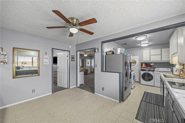 4909 Sepulveda Ave, San Bernardino, CA 92404 - kitchen featuring ceiling fan, independent washer and dryer, a sink, baseboards, and a textured ceiling