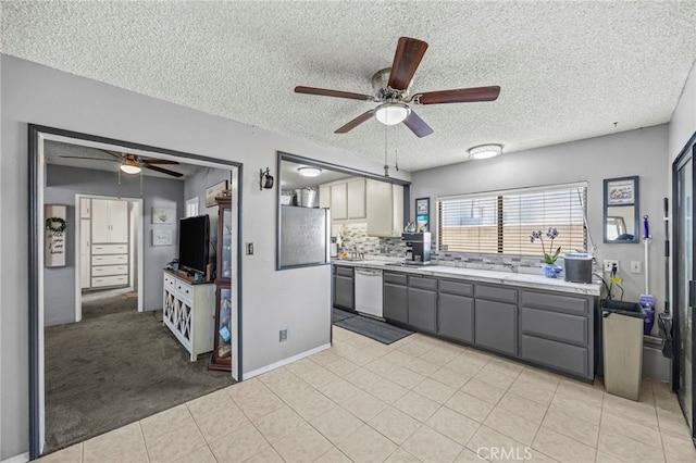 4909 Sepulveda Ave, San Bernardino, CA 92404 - kitchen featuring a ceiling fan, white dishwasher, gray cabinetry, a textured ceiling, and light countertops