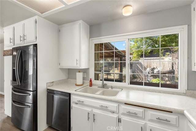 2 Comstock Rd, Chico, CA 95928 - kitchen featuring stainless steel fridge with ice dispenser, dishwashing machine, a sink, light countertops, and white cabinetry