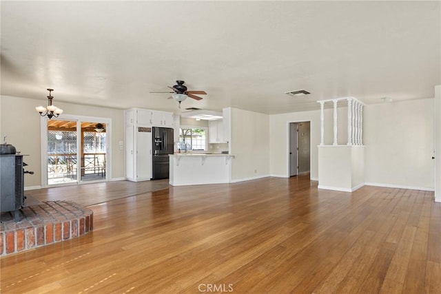 2 Comstock Rd, Chico, CA 95928 - unfurnished living room with a chandelier, ceiling fan, light wood-style floors, and baseboards