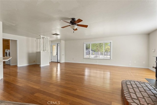 2 Comstock Rd, Chico, CA 95928 - unfurnished living room with washer and clothes dryer, ceiling fan, light wood-style floors, and baseboards