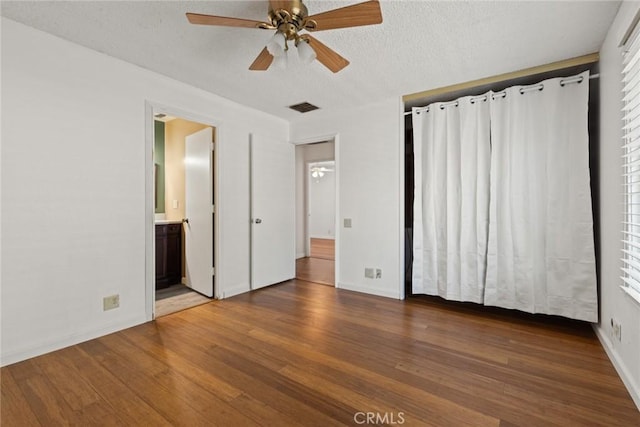 2 Comstock Rd, Chico, CA 95928 - unfurnished bedroom featuring wood finished floors, baseboards, a textured ceiling, connected bathroom, and a ceiling fan
