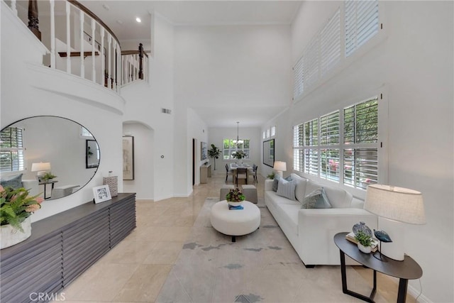 4450 Autumn Glow Ct, Chino Hills, CA 91709 - living area with a high ceiling, light tile patterned floors, baseboards, and a chandelier