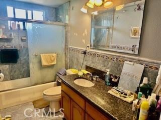 720 Le Borgne Ave, La Puente, CA 91746 - bathroom featuring vanity, toilet, a wainscoted wall, and enclosed tub / shower combo